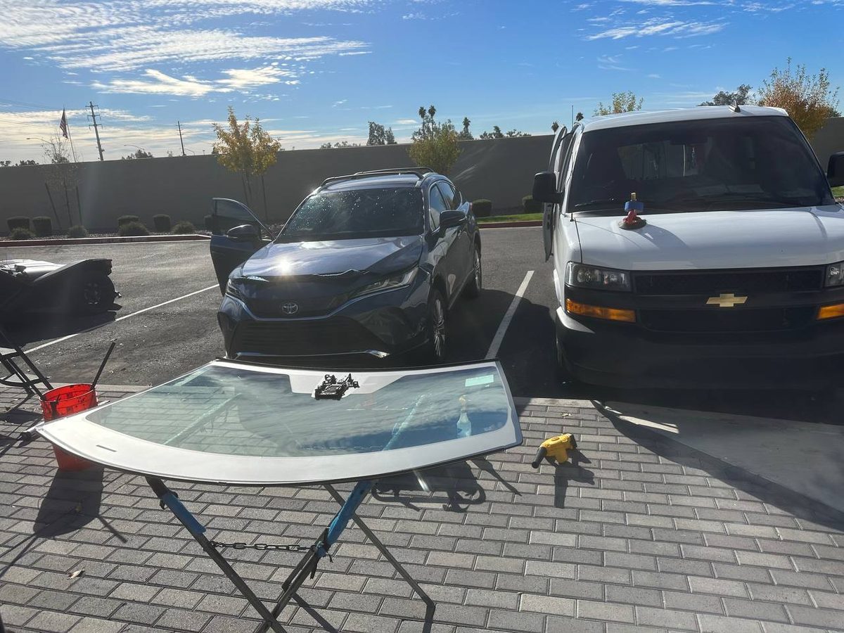 New windshield ready for installation beside the Accent Auto Glass mobile unit